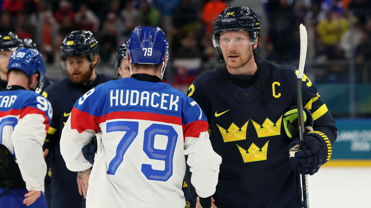 MILAN, ITALY - FEBRUARY 14: Gabriel Landeskog #92 of Team Sweden shakes hands wth Libor Hudacek #79 of Team Slovakia after the Men's Preliminary Group B match between Sweden and Slovakia on day eight of the Milano Cortina 2026 Winter Olympic games at Milano Santagiulia Ice Hockey Arena on February 14, 2026 in Milan, Italy.