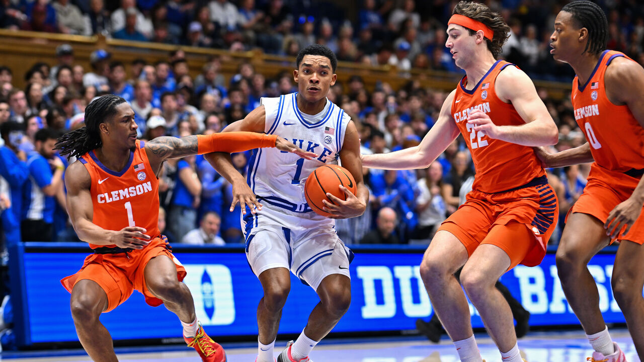 DURHAM, NORTH CAROLINA - FEBRUARY 14: Caleb Foster #1 of the Duke Blue Devils drives to the basket between Jestin Porter #1 and Carter Welling #22 of the Clemson Tigers during the second half of the game at Cameron Indoor Stadium on February 14, 2026 in Durham, North Carolina.