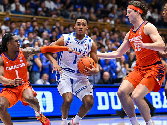 DURHAM, NORTH CAROLINA - FEBRUARY 14: Caleb Foster #1 of the Duke Blue Devils drives to the basket between Jestin Porter #1 and Carter Welling #22 of the Clemson Tigers during the second half of the game at Cameron Indoor Stadium on February 14, 2026 in Durham, North Carolina.