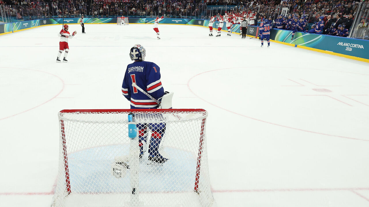MILAN, ITALY - FEBRUARY 14: (EDITOR'S NOTE: Image was captured using a static remote camera behind the goal.) Jeremy Swayman #1 of Team United States reacts after giving up a goal in the first period during the Men's Preliminary Group C match between the United States and Denmark on day eight of the Milano Cortina 2026 Winter Olympic games at Milano Santagiulia Ice Hockey Arena on February 14, 2026 in Milan, Italy.
