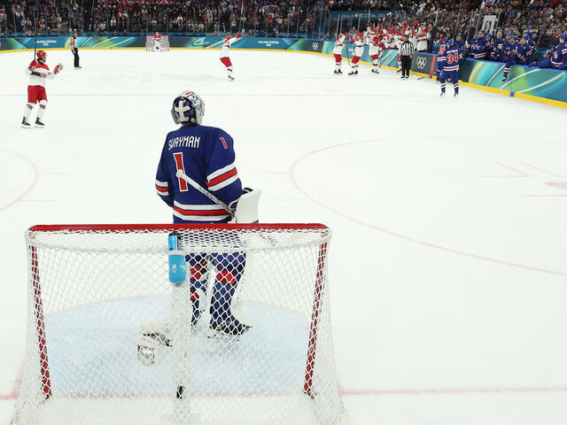 MILAN, ITALY - FEBRUARY 14: (EDITOR'S NOTE: Image was captured using a static remote camera behind the goal.) Jeremy Swayman #1 of Team United States reacts after giving up a goal in the first period during the Men's Preliminary Group C match between the United States and Denmark on day eight of the Milano Cortina 2026 Winter Olympic games at Milano Santagiulia Ice Hockey Arena on February 14, 2026 in Milan, Italy.