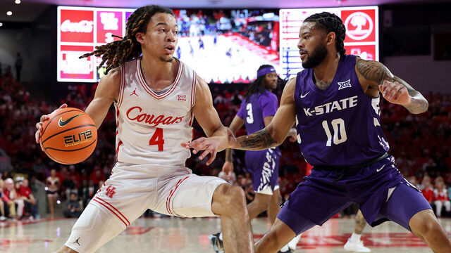 HOUSTON, TEXAS - FEBRUARY 14: Kingston Flemings #4 of the Houston Cougars goes to the basket against David Castillo #10 of the Kansas State Wildcats in the first half at Fertitta Center on February 14, 2026 in Houston, Texas.