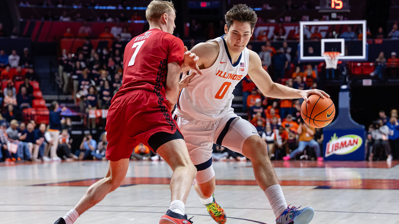 CHAMPAIGN, ILLINOIS - FEBRUARY 10: David Mirkovic #0 of the Illinois Fighting Illini dribbles against Andrew Rohde #7 of the Wisconsin Badgers at State Farm Center on February 10, 2026 in Champaign, Illinois.