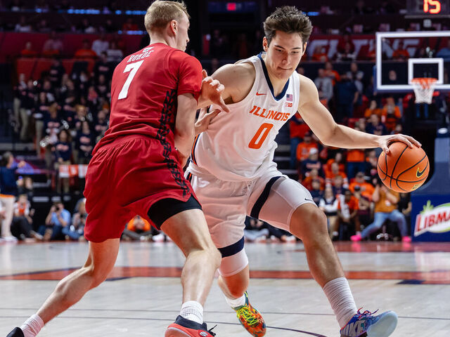 CHAMPAIGN, ILLINOIS - FEBRUARY 10: David Mirkovic #0 of the Illinois Fighting Illini dribbles against Andrew Rohde #7 of the Wisconsin Badgers at State Farm Center on February 10, 2026 in Champaign, Illinois.