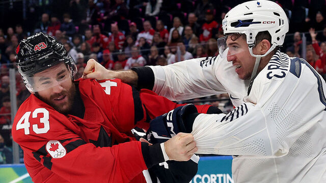 Milan, Italy - February 15, 2026: Pierre Crinon #7 of France, right, fights with Tom Wilson #43 of Canada during the Men's Preliminary Group A match between Canada and France at the 2026 Winter Olympics on February 15, 2026 in Milan, Italy. (Robert Gauthier / Los Angeles Times via Getty Images)