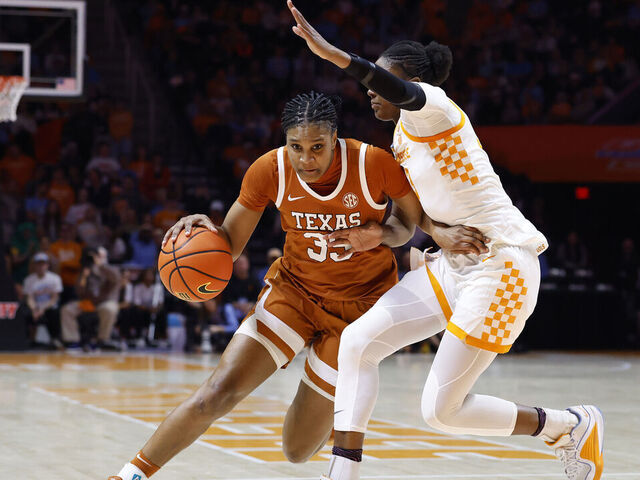 KNOXVILLE, TENNESSEE - FEBRUARY 15: Madison Booker #35 of the Texas Longhorns drives against Alyssa Latham #33 of the Tennessee Volunteers during the second half at Thompson-Boling Arena on February 15, 2026 in Knoxville, Tennessee.