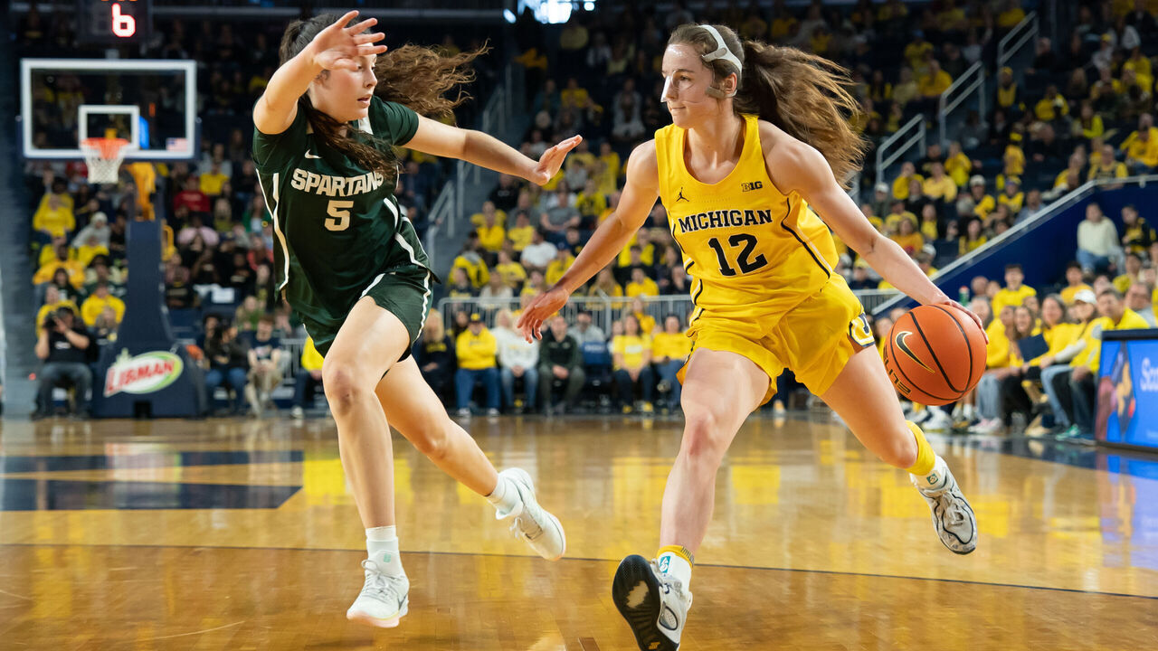 ANN ARBOR, MICHIGAN - FEBRUARY 15: Syla Swords #12 of the Michigan Wolverines drives to the basket against Emma Shumate #5 of the Michigan State Spartans during the second quarter at Crisler Arena on February 15, 2026 in Ann Arbor, Michigan.
