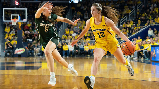 ANN ARBOR, MICHIGAN - FEBRUARY 15: Syla Swords #12 of the Michigan Wolverines drives to the basket against Emma Shumate #5 of the Michigan State Spartans during the second quarter at Crisler Arena on February 15, 2026 in Ann Arbor, Michigan.