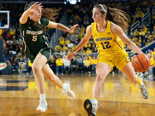 ANN ARBOR, MICHIGAN - FEBRUARY 15: Syla Swords #12 of the Michigan Wolverines drives to the basket against Emma Shumate #5 of the Michigan State Spartans during the second quarter at Crisler Arena on February 15, 2026 in Ann Arbor, Michigan.