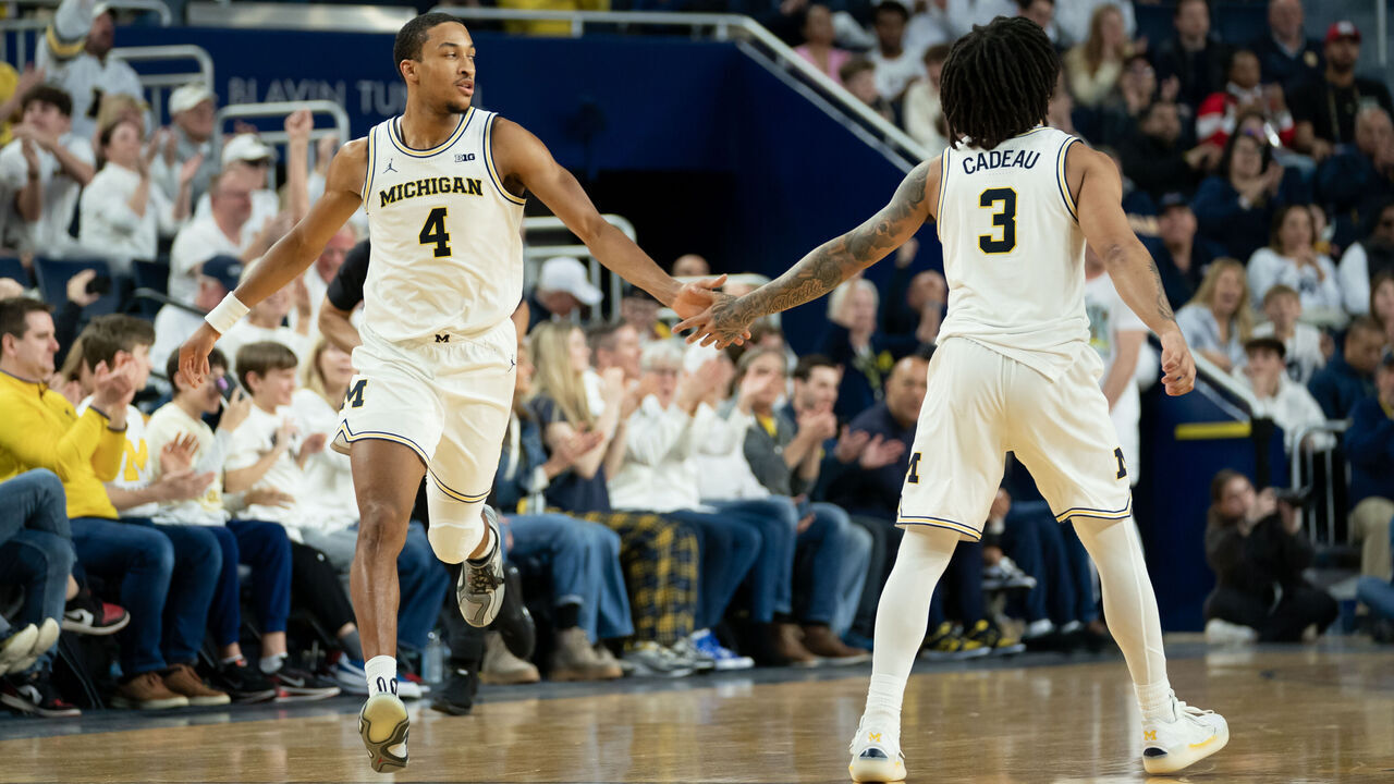 ANN ARBOR, MICHIGAN - FEBRUARY 14: Nimari Burnett #4 of the Michigan Wolverines interacts with Elliot Cadeau #3 after scoring a second half basket against the UCLA Bruins at Crisler Arena on February 14, 2026 in Ann Arbor, Michigan.