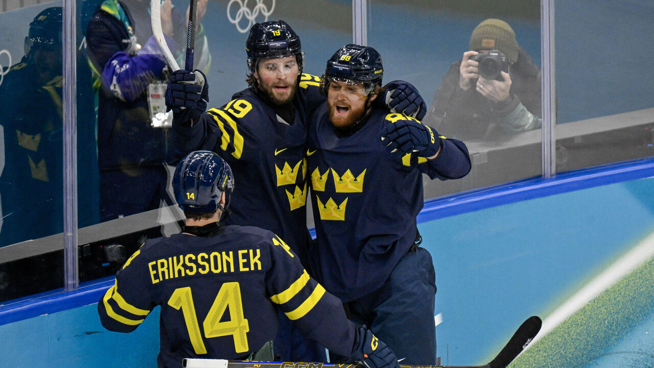 Sweden's #19 Adrian Kempe (C) celebrates scoring their first goal during the men's qualification play-off ice hockey match between Sweden and Latvia at the Milano Santagiulia Ice Hockey Arena during the Milano Cortina 2026 Winter Olympic Games in Milan, on February 17, 2026.