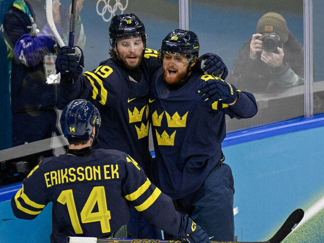 Sweden's #19 Adrian Kempe (C) celebrates scoring their first goal during the men's qualification play-off ice hockey match between Sweden and Latvia at the Milano Santagiulia Ice Hockey Arena during the Milano Cortina 2026 Winter Olympic Games in Milan, on February 17, 2026.