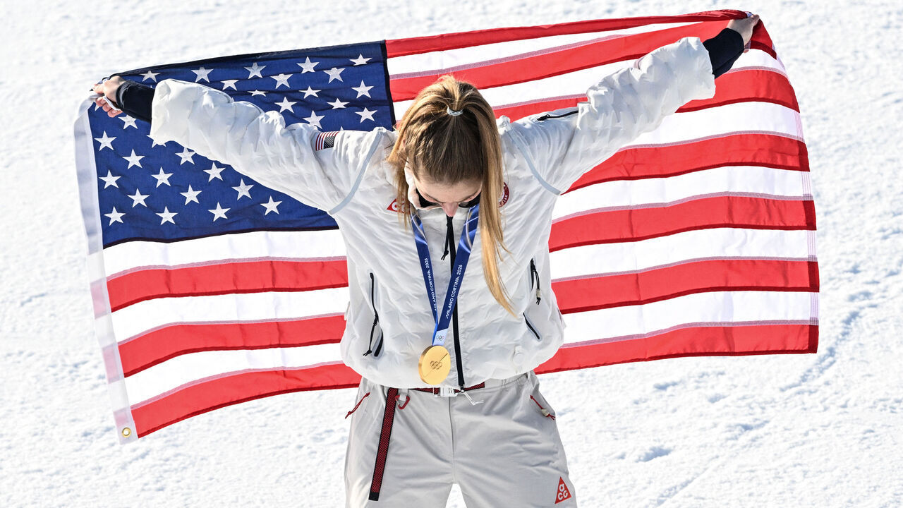 Gold medallist USA's Mikaela Shiffrin celebrates with the national after the women's slalom event during the Milano Cortina 2026 Winter Olympic Games at the Tofane Alpine Skiing Centre in Cortina d'Ampezzo on February 18, 2026.