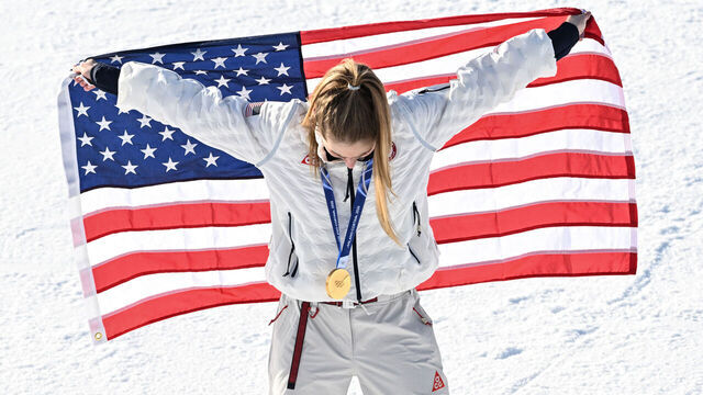 Gold medallist USA's Mikaela Shiffrin celebrates with the national after the women's slalom event during the Milano Cortina 2026 Winter Olympic Games at the Tofane Alpine Skiing Centre in Cortina d'Ampezzo on February 18, 2026.