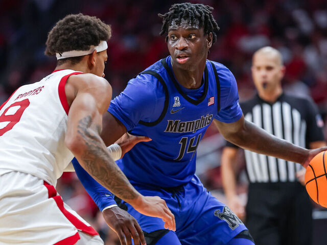 LOUISVILLE, KENTUCKY - DECEMBER 13: Hasan Abdul Hakim #14 of the Memphis Tigers dribbles against Khani Rooths #9 of the Louisville Cardinals during the game against the Louisville Cardinals at KFC YUM! Center on December 13, 2025 in Louisville, Kentucky.