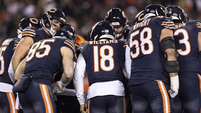 CHICAGO, ILLINOIS - JANUARY 18: Caleb Williams #18 of the Chicago Bears leads a huddle during an NFL divisional playoff football game against the Los Angeles Rams at Soldier Field on January 18, 2026 in Chicago, Illinois.