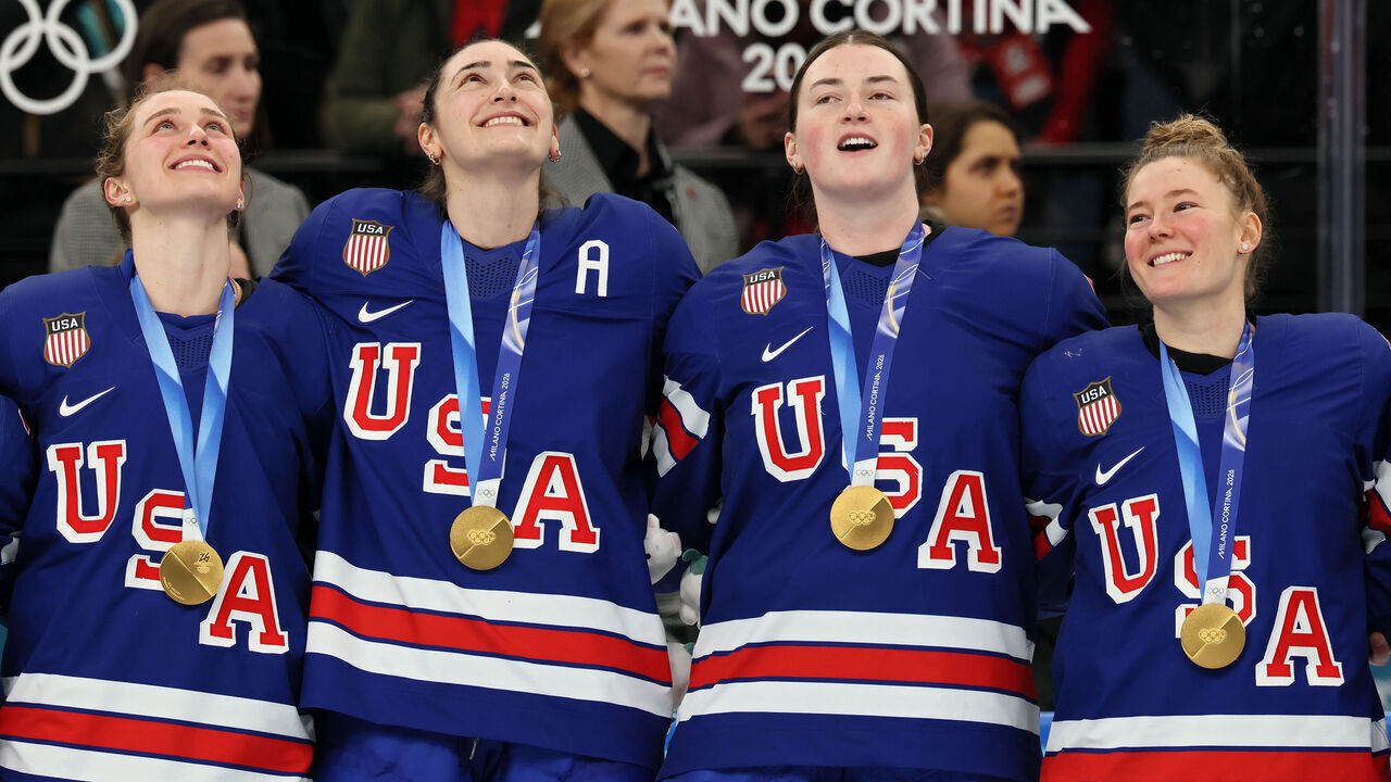 MILAN, ITALY - FEBRUARY 19: Gold medalists Caroline Harvey #4, Megan Keller #5, Rory Guilday #6 and Haley Winn #8 of Team United States participate in the national anthem during the medal ceremony for the Ice Hockey Women following during the Women's Gold Medal match between the United States and Canada on day thirteen of the Milano Cortina 2026 Winter Olympic games at Milano Santagiulia Ice Hockey Arena on February 19, 2026 in Milan, Italy.