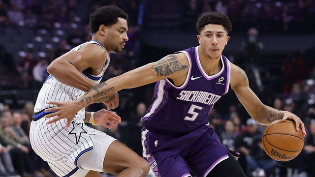 SACRAMENTO, CALIFORNIA - FEBRUARY 19: Nique Clifford #5 of the Sacramento Kings drives to the basket against Jett Howard #13 of the Orlando Magic in the first quarter at Golden 1 Center on February 19, 2026 in Sacramento, California.