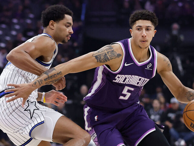SACRAMENTO, CALIFORNIA - FEBRUARY 19: Nique Clifford #5 of the Sacramento Kings drives to the basket against Jett Howard #13 of the Orlando Magic in the first quarter at Golden 1 Center on February 19, 2026 in Sacramento, California.
