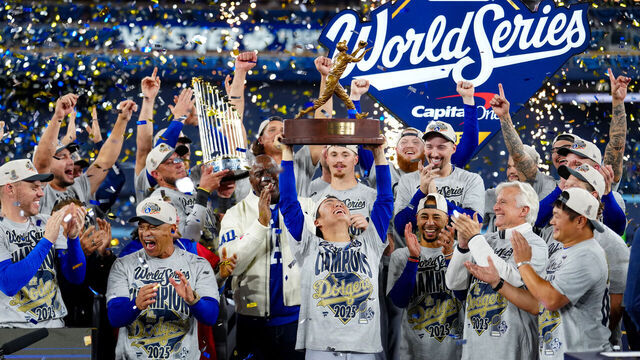 TORONTO, ON - NOVEMBER 01: Yoshinobu Yamamoto #18 of the Los Angeles Dodgers hoists the 2025 Willie Mays World Series Most Valuable Player trophy after the Dodgers defeated the Toronto Blue Jays in Game Seven of the 2025 World Series presented by Capital One between the Los Angeles Dodgers and the Toronto Blue Jays at Rogers Centre on Saturday, November 1, 2025 in Toronto, Ontario, Canada.