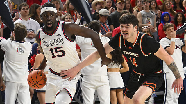 SPOKANE, WASHINGTON - FEBRUARY 21: Graham Ike #15 of the Gonzaga Bulldogs drives past Isaac Jack #14 of the Pacific Tigers during the first half of the game at McCarthey Athletic Center on February 21, 2026 in Spokane, Washington.