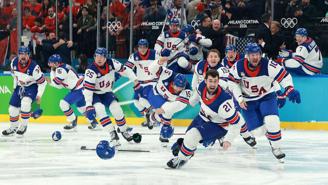 MILAN, ITALY - FEBRUARY 22: Players of Team United States celebrate a 2-1 victory against Canada in overtime for the gold medal during the Men's Gold Medal match between Canada and the United States on day 16 of the Milano Cortina 2026 Winter Olympic games at Milano Santagiulia Ice Hockey Arena on February 22, 2026 in Milan, Italy.