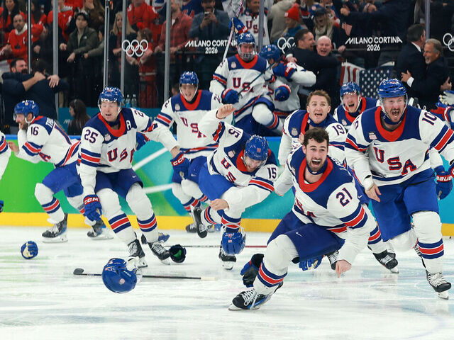 MILAN, ITALY - FEBRUARY 22: Players of Team United States celebrate a 2-1 victory against Canada in overtime for the gold medal during the Men's Gold Medal match between Canada and the United States on day 16 of the Milano Cortina 2026 Winter Olympic games at Milano Santagiulia Ice Hockey Arena on February 22, 2026 in Milan, Italy.