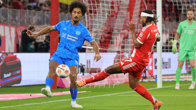 MUNICH, GERMANY - NOVEMBER 1: Loic Bade of Bayer 04 Leverkusen (L) and Serge Gnabry of FC Bayern München compete for the ball during the Bundesliga match between FC Bayern München and Bayer 04 Leverkusen at Allianz Arena on November 1, 2025 in Munich, Germany.