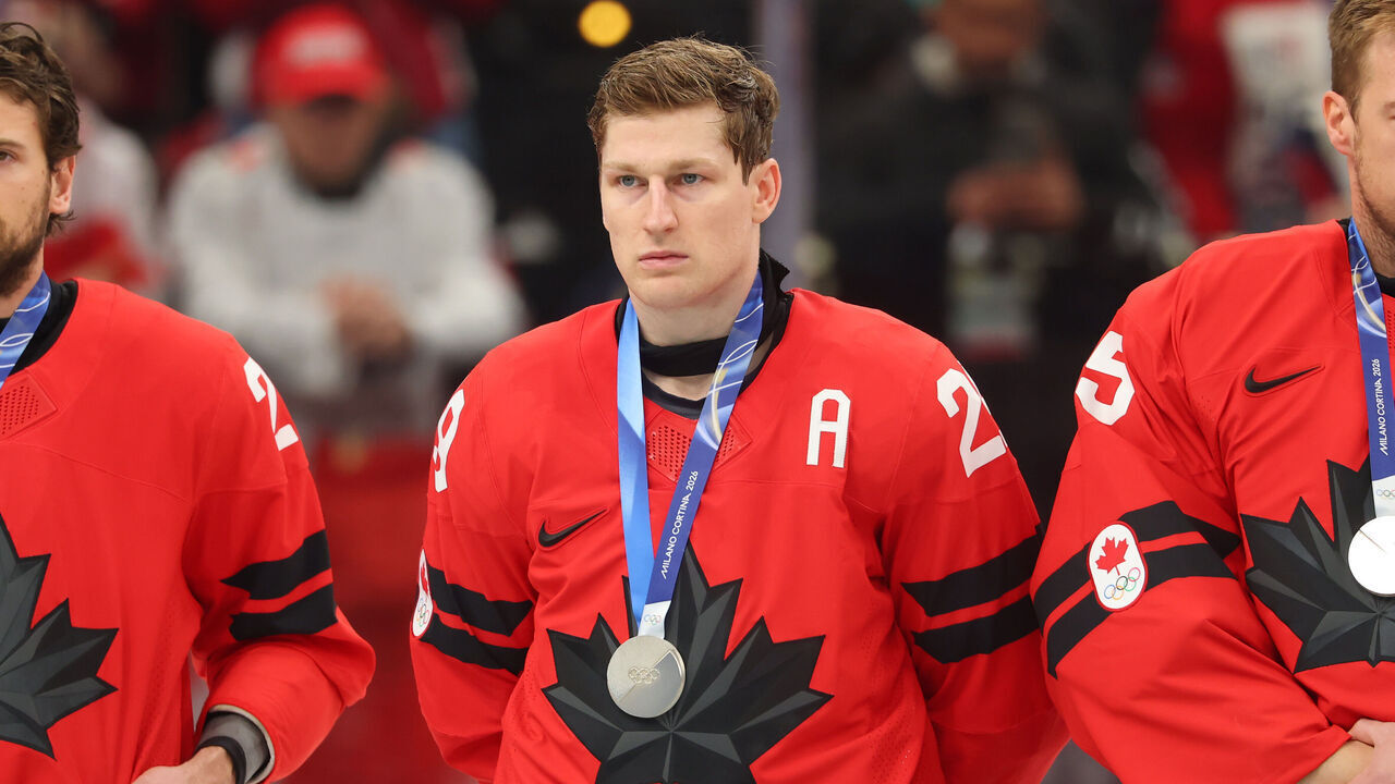 MILAN, ITALY - FEBRUARY 22: (L-R) Silver medalists Shea Theodore #27, Nathan MacKinnon #29 and Darcy Kuemper #35 of Team Canada show dejection during the medal ceremony following the Men's Gold Medal match between Canada and the United States on day 16 of the Milano Cortina 2026 Winter Olympic games at Milano Santagiulia Ice Hockey Arena on February 22, 2026 in Milan, Italy.