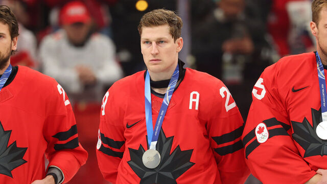 MILAN, ITALY - FEBRUARY 22: (L-R) Silver medalists Shea Theodore #27, Nathan MacKinnon #29 and Darcy Kuemper #35 of Team Canada show dejection during the medal ceremony following the Men's Gold Medal match between Canada and the United States on day 16 of the Milano Cortina 2026 Winter Olympic games at Milano Santagiulia Ice Hockey Arena on February 22, 2026 in Milan, Italy.