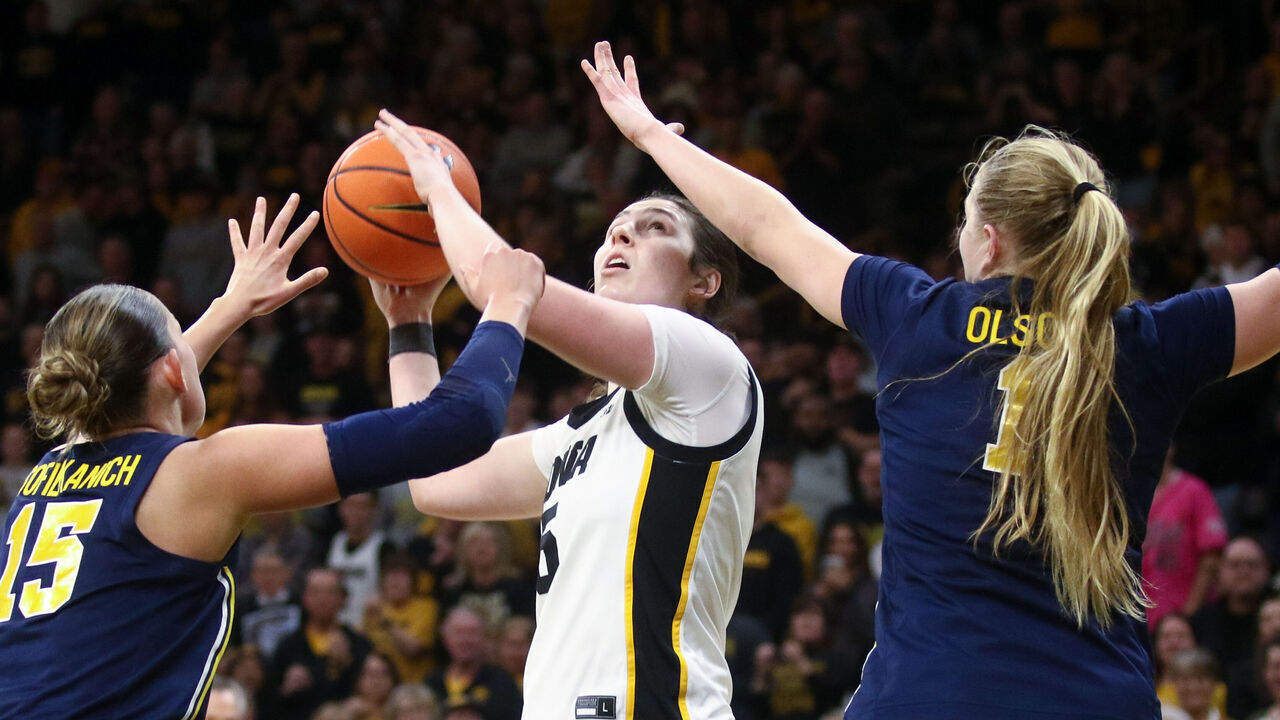 IOWA CITY, IA - FEBRUARY 22: Center Ava Heiden #5 of the Iowa Hawkeyes goes to the basket in the second half against forward Ashley Sofilkanich #15 and guard Olivia Olson #1 of the Michigan Wolverines on February 22, 2026 at Carver-Hawkeye Arena, in Iowa City, Iowa.