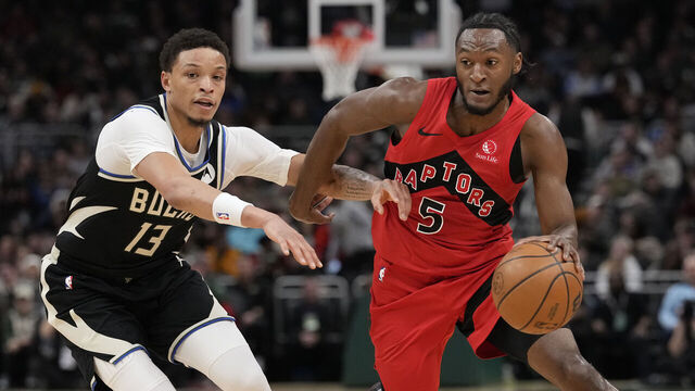 MILWAUKEE, WISCONSIN - FEBRUARY 22: Immanuel Quickley #5 of the Toronto Raptors dribbles the ball against Ryan Rollins #13 of the Milwaukee Bucks during the first quarter at Fiserv Forum on February 22, 2026 in Milwaukee, Wisconsin.