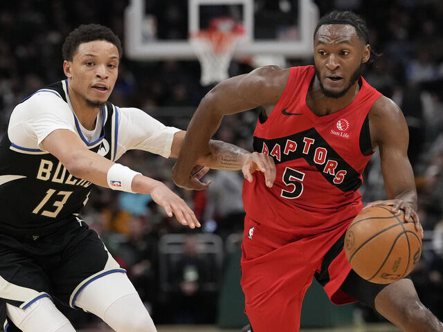 MILWAUKEE, WISCONSIN - FEBRUARY 22: Immanuel Quickley #5 of the Toronto Raptors dribbles the ball against Ryan Rollins #13 of the Milwaukee Bucks during the first quarter at Fiserv Forum on February 22, 2026 in Milwaukee, Wisconsin.