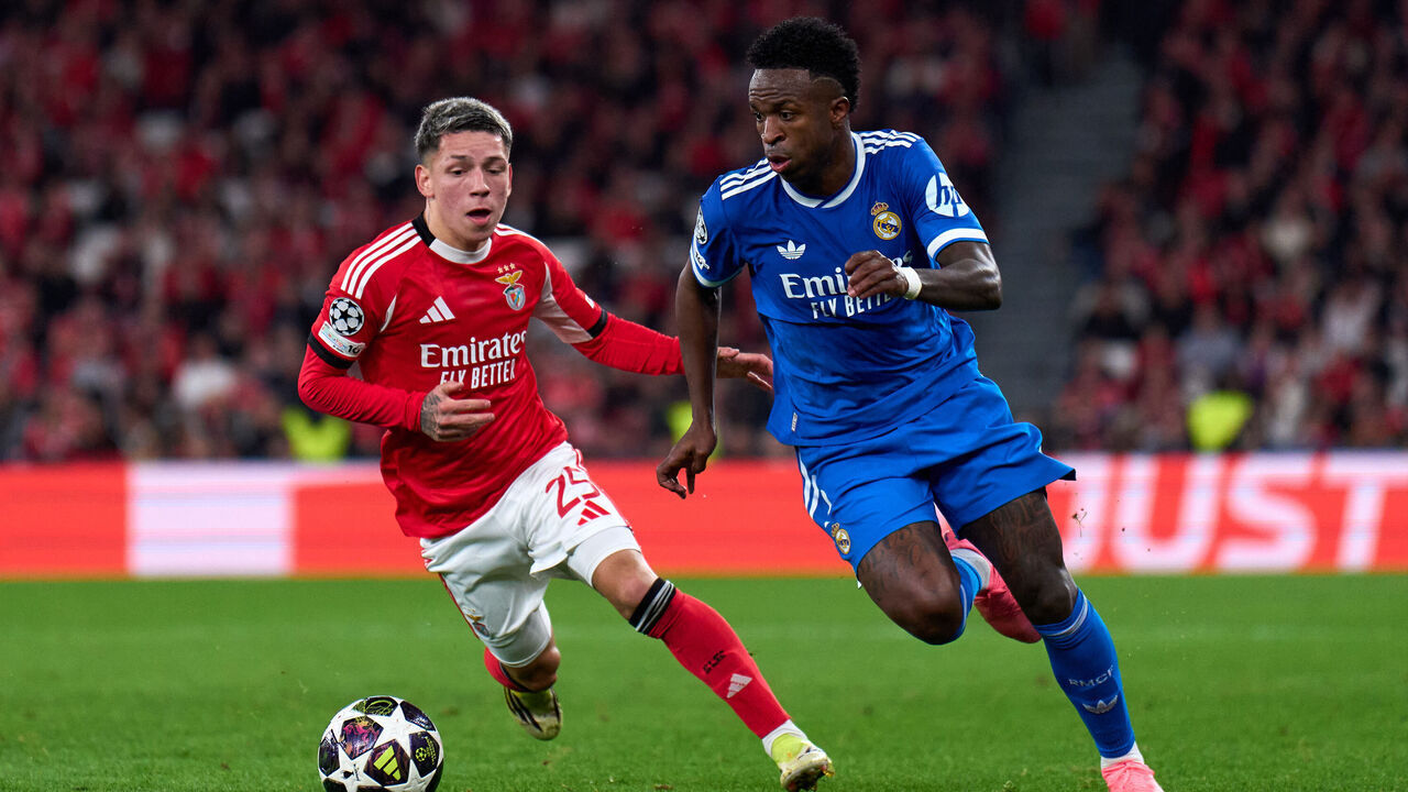 LISBON, PORTUGAL - FEBRUARY 17: Vinicius Junior of Real Madrid is challenged by Gianluca Prestianni of SL Benfica during the UEFA Champions League 2025/26 League Knockout Play-off First Leg match between SL Benfica and Real Madrid C.F. at Estadio do SL Benfica on February 17, 2026 in Lisbon, Portugal.
