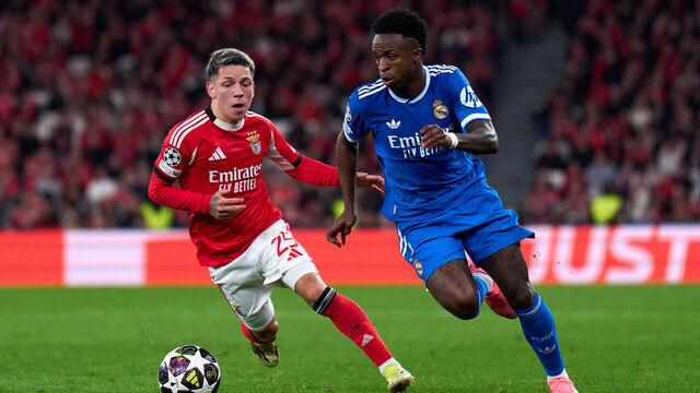 LISBON, PORTUGAL - FEBRUARY 17: Vinicius Junior of Real Madrid is challenged by Gianluca Prestianni of SL Benfica during the UEFA Champions League 2025/26 League Knockout Play-off First Leg match between SL Benfica and Real Madrid C.F. at Estadio do SL Benfica on February 17, 2026 in Lisbon, Portugal.