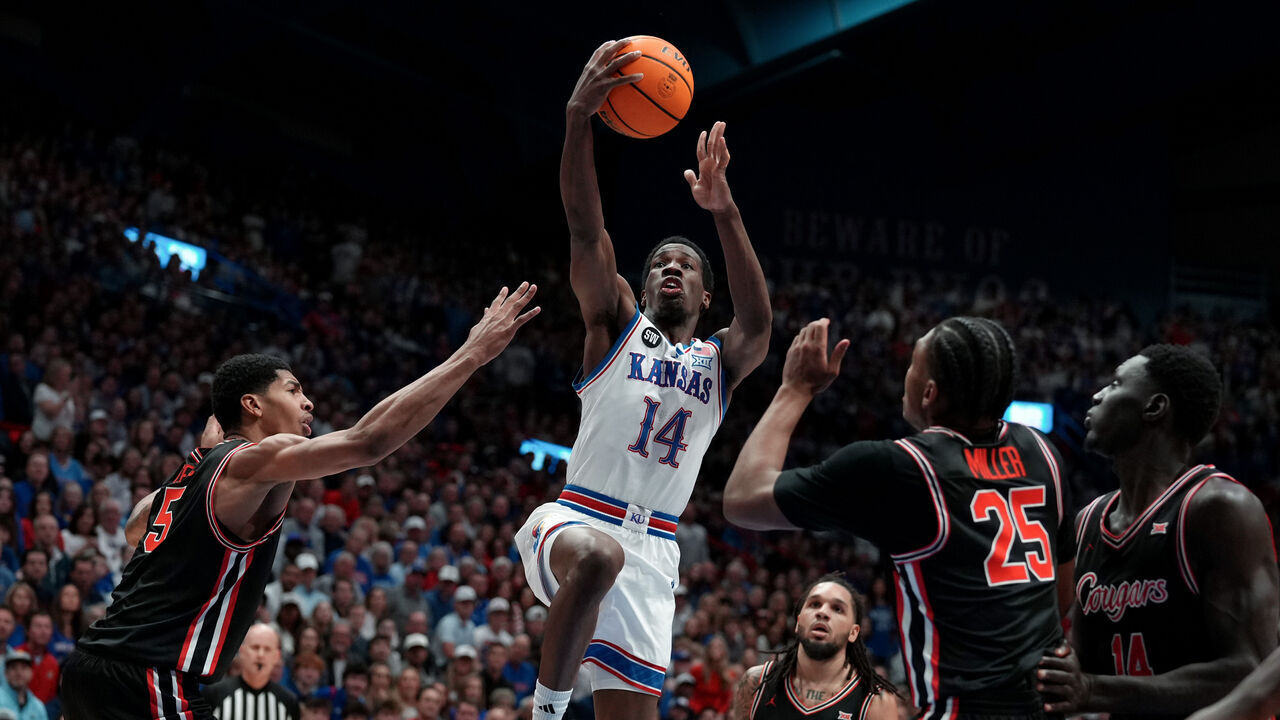 LAWRENCE, KANSAS - FEBRUARY 23: Guard Melvin Council Jr. #14 of the Kansas Jayhawks lays the ball up against forward Chris Cenac Jr. #5, guard Emanuel Sharp #21and guard Mercy Miller #25 of the Houston Cougars in the first half at Allen Fieldhouse on February 23, 2026 in Lawrence, Kansas.
