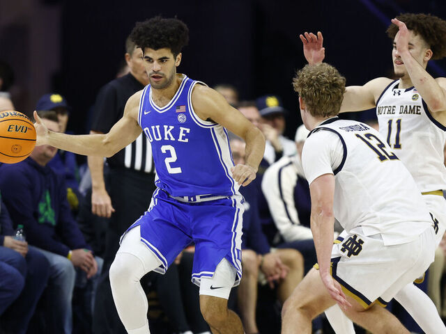 SOUTH BEND, IN - FEBRUARY 24: Duke Blue Devils guard Cayden Boozer (2) moves with the ball while defended by Notre Dame Fighting Irish forward Garrett Sundra (12) and Notre Dame Fighting Irish guard Braeden Shrewsberry (11) in the first half of play during a men's college basketball game between the Duke Blue Devils and the Notre Dame Fighting Irish on February 24, 2026 at Purcell Pavilion in South Bend, IN.