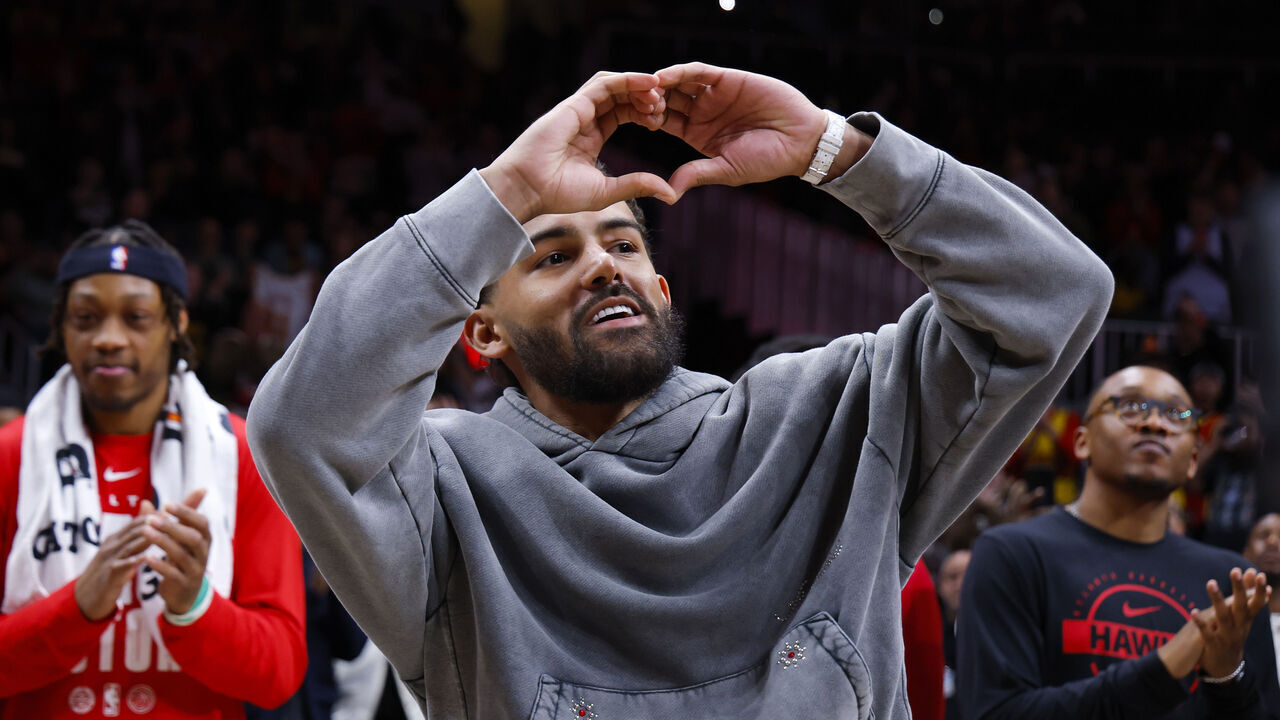 ATLANTA, GEORGIA - FEBRUARY 24: Trae Young #3 of the Washington Wizards gestures to the crowd as a tribute is shown during the second quarter against the Atlanta Hawks at State Farm Arena on February 24, 2026 in Atlanta, Georgia.