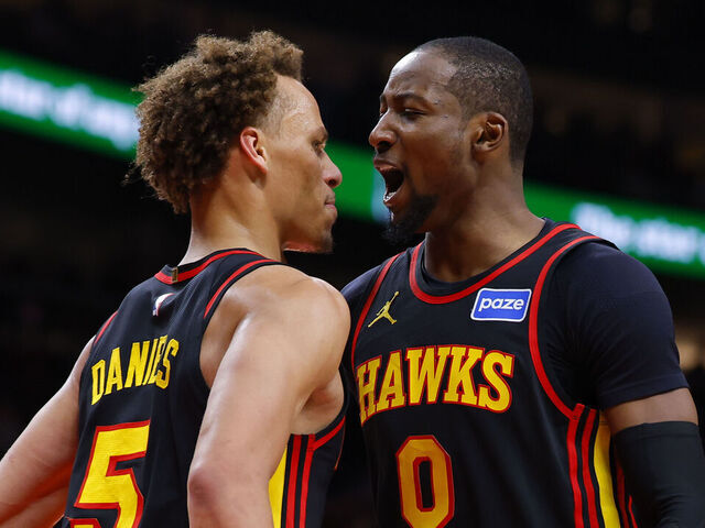 ATLANTA, GEORGIA - FEBRUARY 24: Jonathan Kuminga #0 of the Atlanta Hawks reacts with Dyson Daniels #5 during the third quarter against the Washington Wizards at State Farm Arena on February 24, 2026 in Atlanta, Georgia.