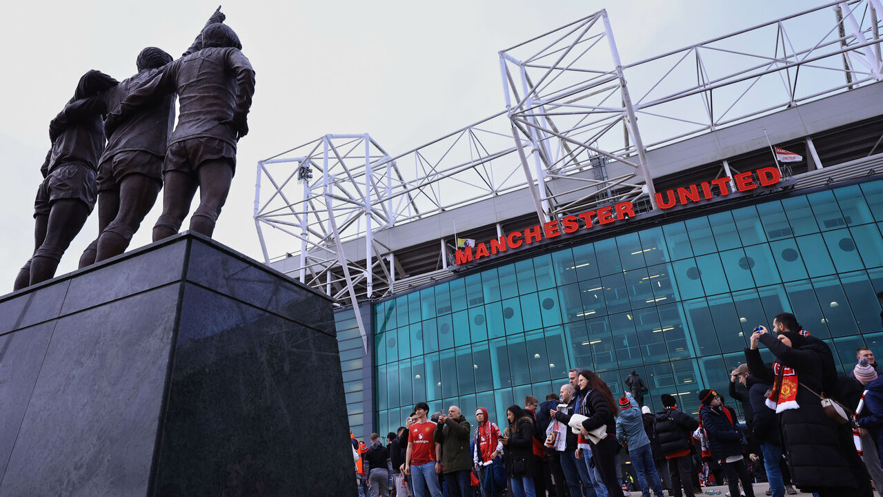MANCHESTER, ENGLAND - FEBRUARY 07: Fans pose for photos in front of the Holy Trinity statue of George Best, Denis Law, and Sir Bobby Charlton prior to the Premier League match between Manchester United and Tottenham Hotspur at Old Trafford on February 07, 2026 in Manchester, England.
