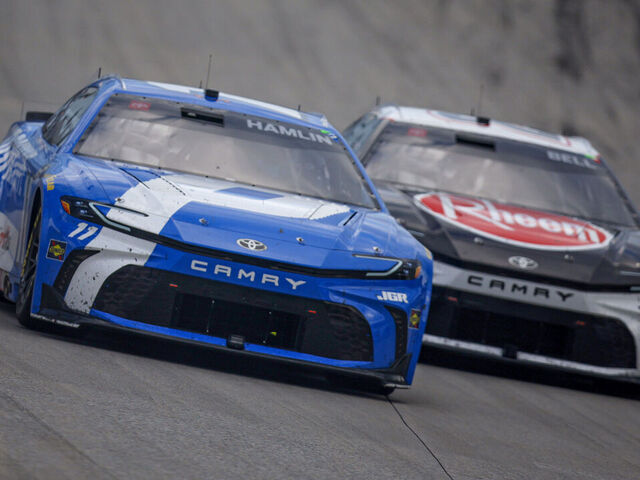 DOVER, DELAWARE - JULY 20: Denny Hamlin, driver of the #11 Progressive Toyota, and Christopher Bell, driver of the #20 Rheem Toyota, race during the NASCAR Cup Series AutoTrader EchoPark Automotive 400 at Dover Motor Speedway on July 20, 2025 in Dover, Delaware.