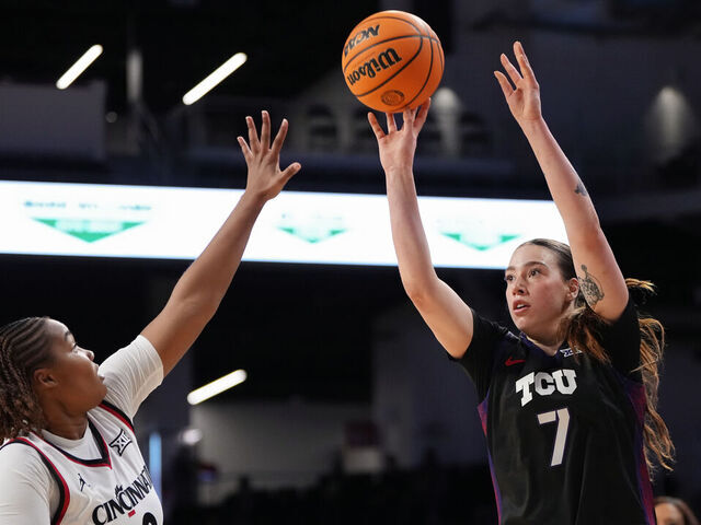 CINCINNATI, OHIO - FEBRUARY 25: Marta Suarez #7 of the TCU Horned Frogs attempts a shot while being guarded by Joya Crawford #8 of the Cincinnati Bearcats in the first quarter at Fifth Third Arena on February 25, 2026 in Cincinnati, Ohio.