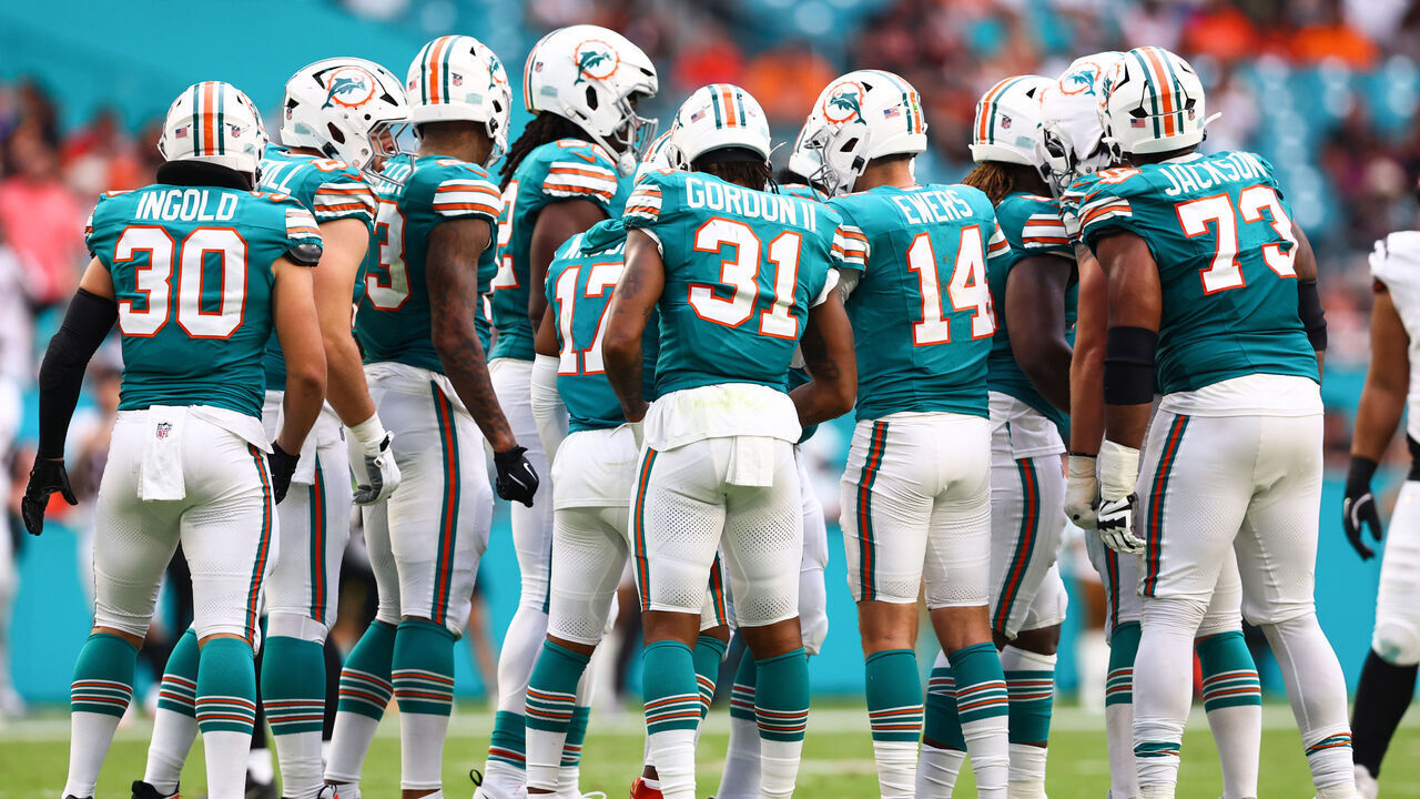 MIAMI GARDENS, FLORIDA - DECEMBER 21: Quinn Ewers #14 of the Miami Dolphins huddles with teammates during the second half of the game against the Cincinnati Bengals at Hard Rock Stadium on December 21, 2025 in Miami Gardens, Florida.
