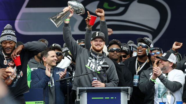 SEATTLE, WASHINGTON - FEBRUARY 11: Sam Darnold #14 of the Seattle Seahawks raises the Lombardi Trophy during the Seattle Seahawks Super Bowl LX victory celebration and parade at Lumen Field on February 11, 2026 in Seattle, Washington.