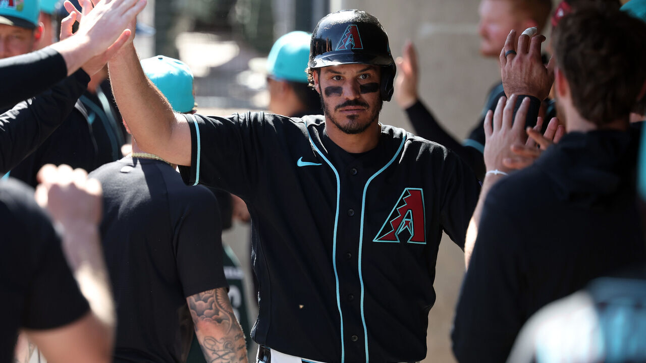 SCOTTSDALE, ARIZONA - FEBRUARY 25: Nolan Arenado #28 of the Arizona Diamondbacks high fives teammates in the dugout after scoring a run against the Los Angeles Dodgers in the first inning of a spring training game at Salt River Fields at Talking Stick on February 25, 2026 in Scottsdale, Arizona.