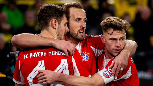 DORTMUND, GERMANY - FEBRUARY 28: Harry Kane of Bayern Munchen celebrates with Josip Stanisic of Bayern Munchen and Joshua Kimmich of Bayern Munchen after scoring his team's second goal during the Bundesliga match between Borussia Dortmund and FC Bayern Munchen at Signal Iduna Park on February 28, 2026 in Dortmund, Germany.