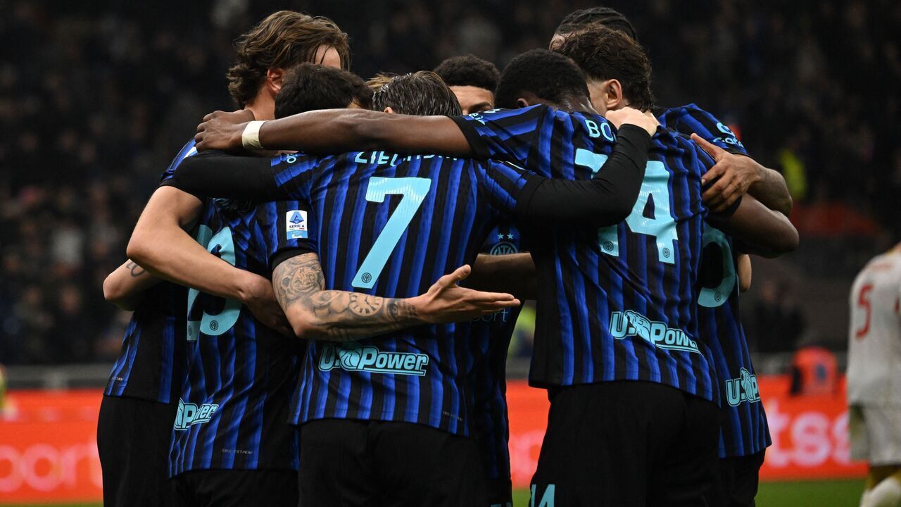 Inter Milan's Turkish midfielder #20 Hakan Calhanoglu celebrates with teammates after scoring his team's second goal in a penalty kick during the Italian Serie A football match between Inter Milan and Genoa at the San Siro Stadium in Milan on February 28, 2026.