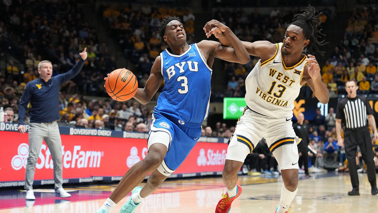 MORGANTOWN, WEST VIRGINIA - FEBRUARY 28: AJ Dybantsa #3 of the BYU Cougars drives to the basket against Chance Moore #13 of the West Virginia Mountaineers in the first half of a college basketball game at Hope Coliseum on February 28, 2026 in Morgantown, West Virginia.