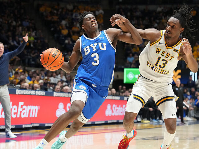 MORGANTOWN, WEST VIRGINIA - FEBRUARY 28: AJ Dybantsa #3 of the BYU Cougars drives to the basket against Chance Moore #13 of the West Virginia Mountaineers in the first half of a college basketball game at Hope Coliseum on February 28, 2026 in Morgantown, West Virginia.