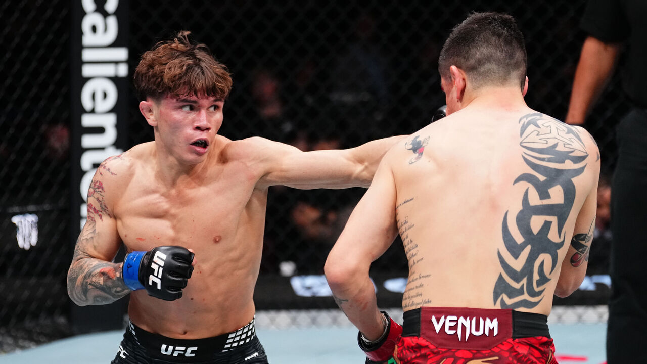 MEXICO CITY, MEXICO - FEBRUARY 28: (L-R) Lone'er Kavanagh of England punches Brandon Moreno of Mexico in a flyweight fight during the UFC Fight Night event at Arena CDMX on February 28, 2026 in Mexico City, Mexico.